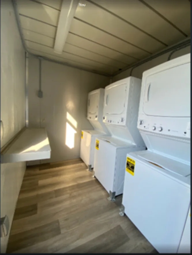 Laundry container with rows of washing machines