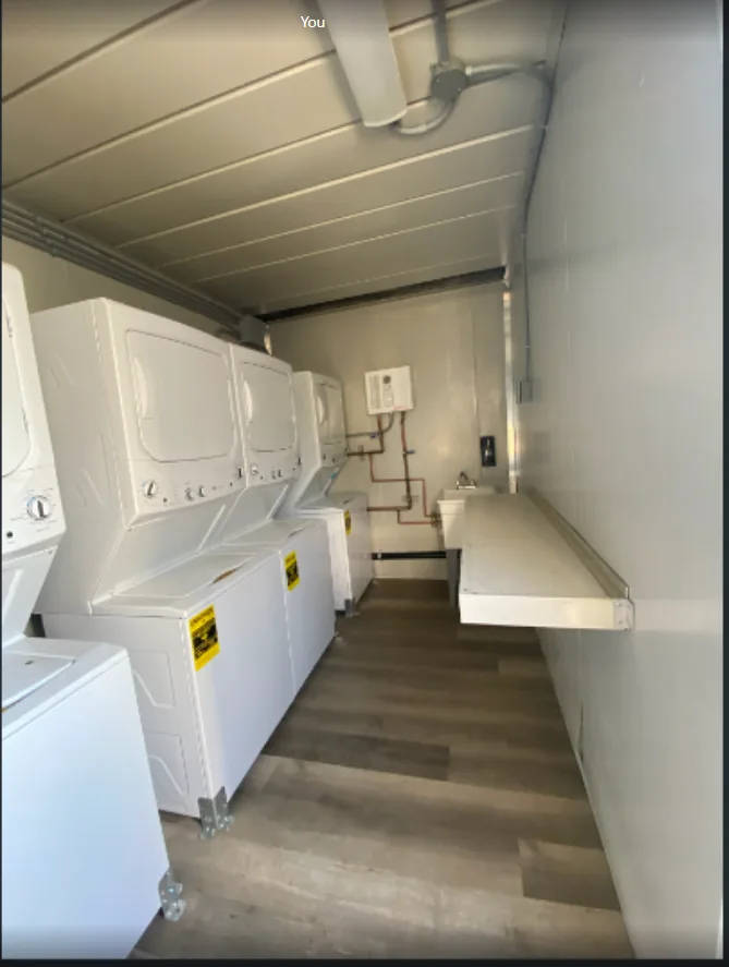 Laundry container with rows of washing machines